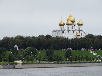 View of trees and building against sky