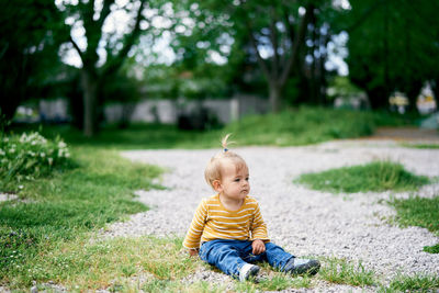 Boy sitting on field