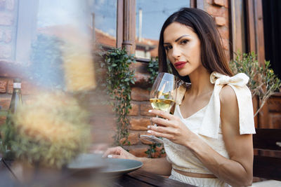 Young woman drinking water from glass