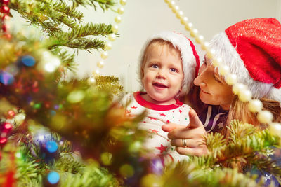 Portrait of cute girl decorating christmas tree