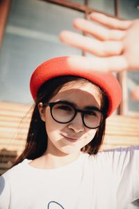 Portrait of teenage girl shielding eyes during sunny day