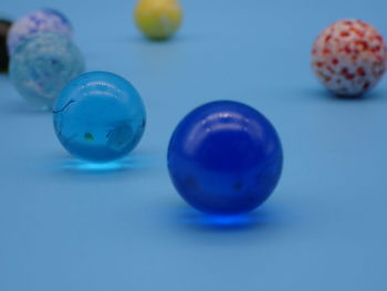 Close-up of blue glass marbles on table