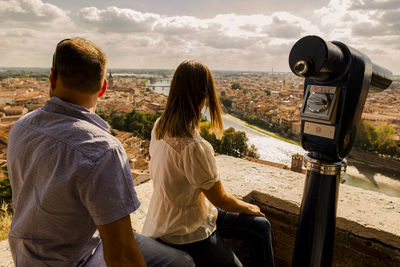 Rear view of people looking at city