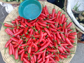 High angle view of red chili pepper in basket at market