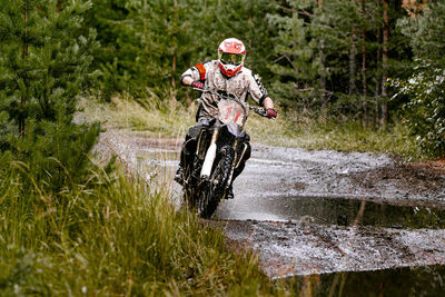 Man riding motorbike in forest