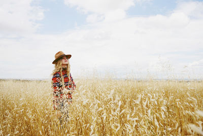 Hay bales on field against sky