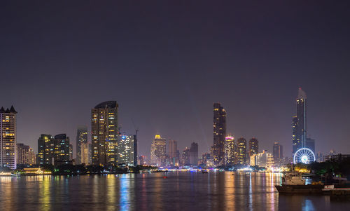 Illuminated buildings in city at night