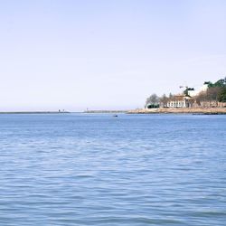 Calm sea against clear blue sky