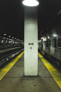 Illuminated subway station platform at night