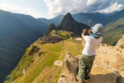 Rear view full length of woman photographing machu picchu
