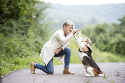 Senior woman teaching her dog