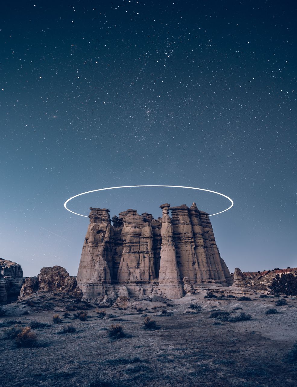 LOW ANGLE VIEW OF ROCK FORMATION AGAINST SKY AT NIGHT