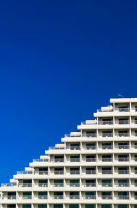 Low angle view of building against clear blue sky