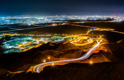 High angle view of illuminated light trails on road in city