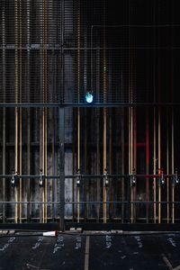 Padlocks hanging on building gate at night