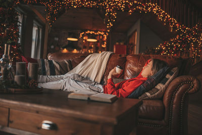 Portrait of candid authentic dreamer boy teenager in sadness depressing emotion at home xmas