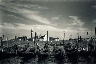 View of harbor against cloudy sky