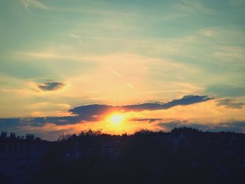 Silhouette trees against sky during sunset