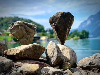 Rocks by sea against sky