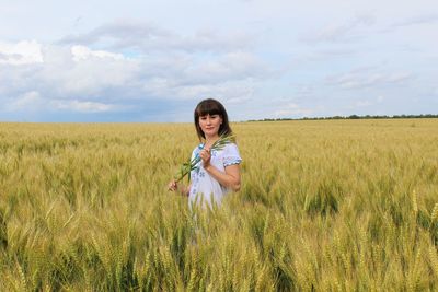 Portrait of girl standing in wheat field