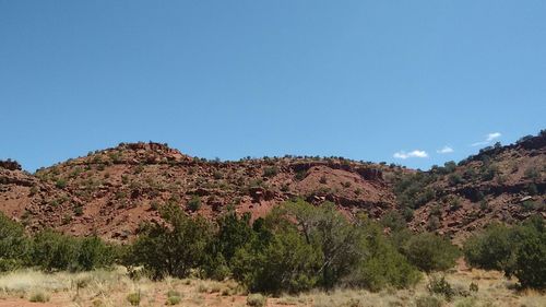 Scenic view of mountains against clear blue sky