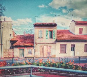 Buildings against cloudy sky