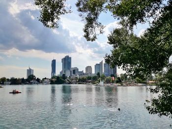 Panoramic view of buildings and trees against sky