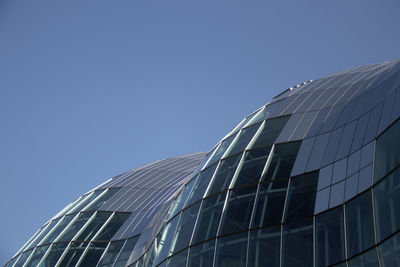 Low angle view of modern building against clear blue sky