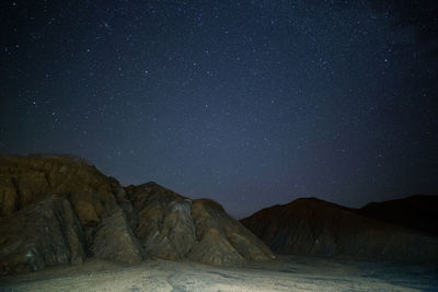 Low angle view of mountain against sky at night