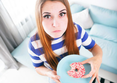 High angle view of woman eating donut