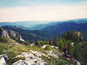 Rear view of man on mountains against sky