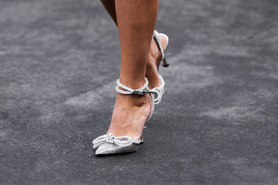 Low section of man standing on road