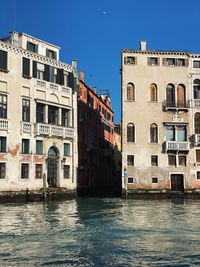 Palaces facades along the grand canal in venice italy with sunlight and blue sky copy space 