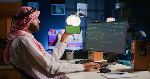 Midsection of woman using mobile phone while working at office