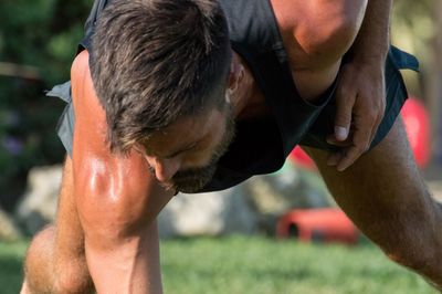 Close-up of man exercising in lawn