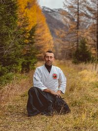 Portrait of man sitting on field