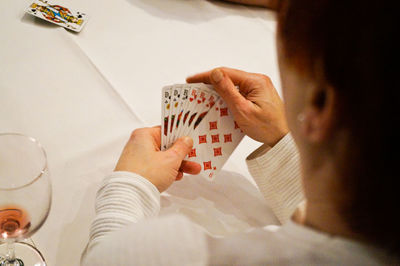 High angle view of person playing cards