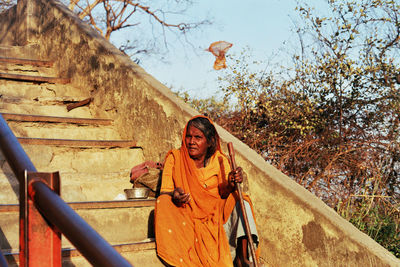 Beggar sitting on steps