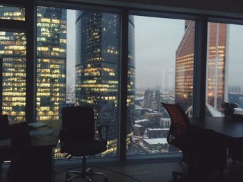 Cityscape against sky seen through glass window