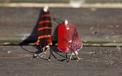 Two fishing lures lying on old wooden plank