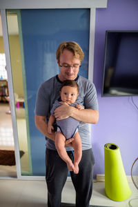 Father with baby standing outdoors