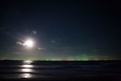 Scenic view of sea against sky at night