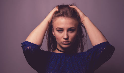 Portrait of beautiful woman against wall