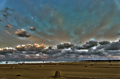 Scenic view of landscape against storm clouds