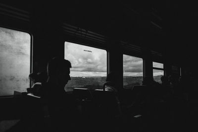 Silhouette people sitting in bus