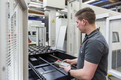 Man operating machine in factory