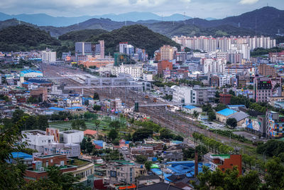 Suncheon train station and the surrounding city and mountains. suncheon, south korea.