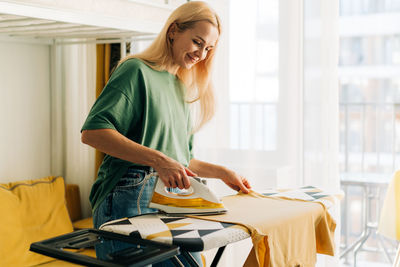 Side view of young woman working at office