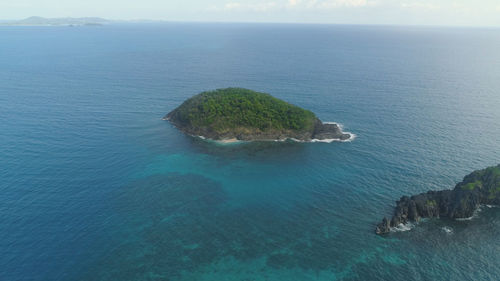 High angle view of rocks by sea against sky