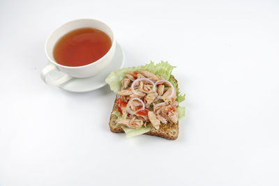 High angle view of breakfast on table against white background